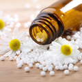 Homeopathic pills on rustic wood with warm bokeh